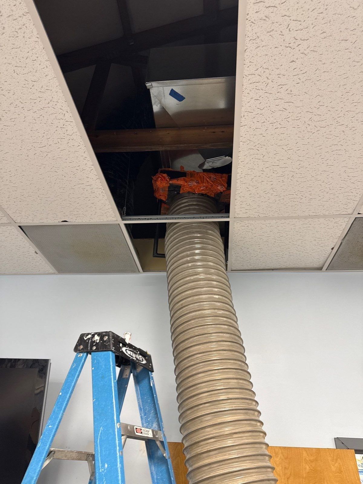 Duct cleaning equipment connected through a ceiling opening