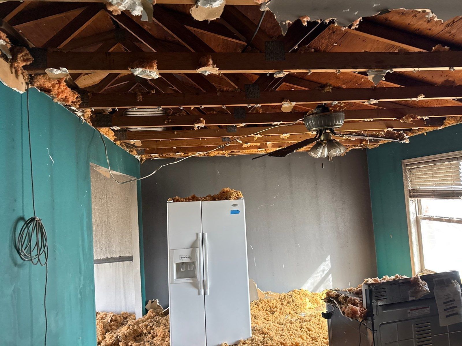 A fire-damaged kitchen during demolition