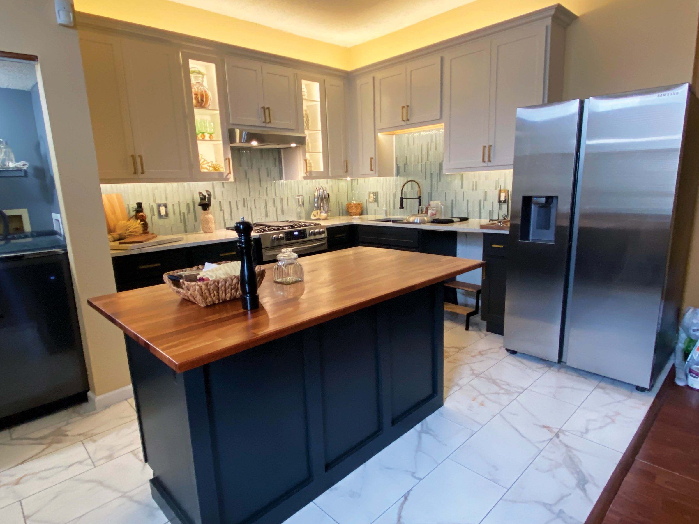 A kitchen Sansara rebuilt after damage, with new cabinets and a butcher-block island