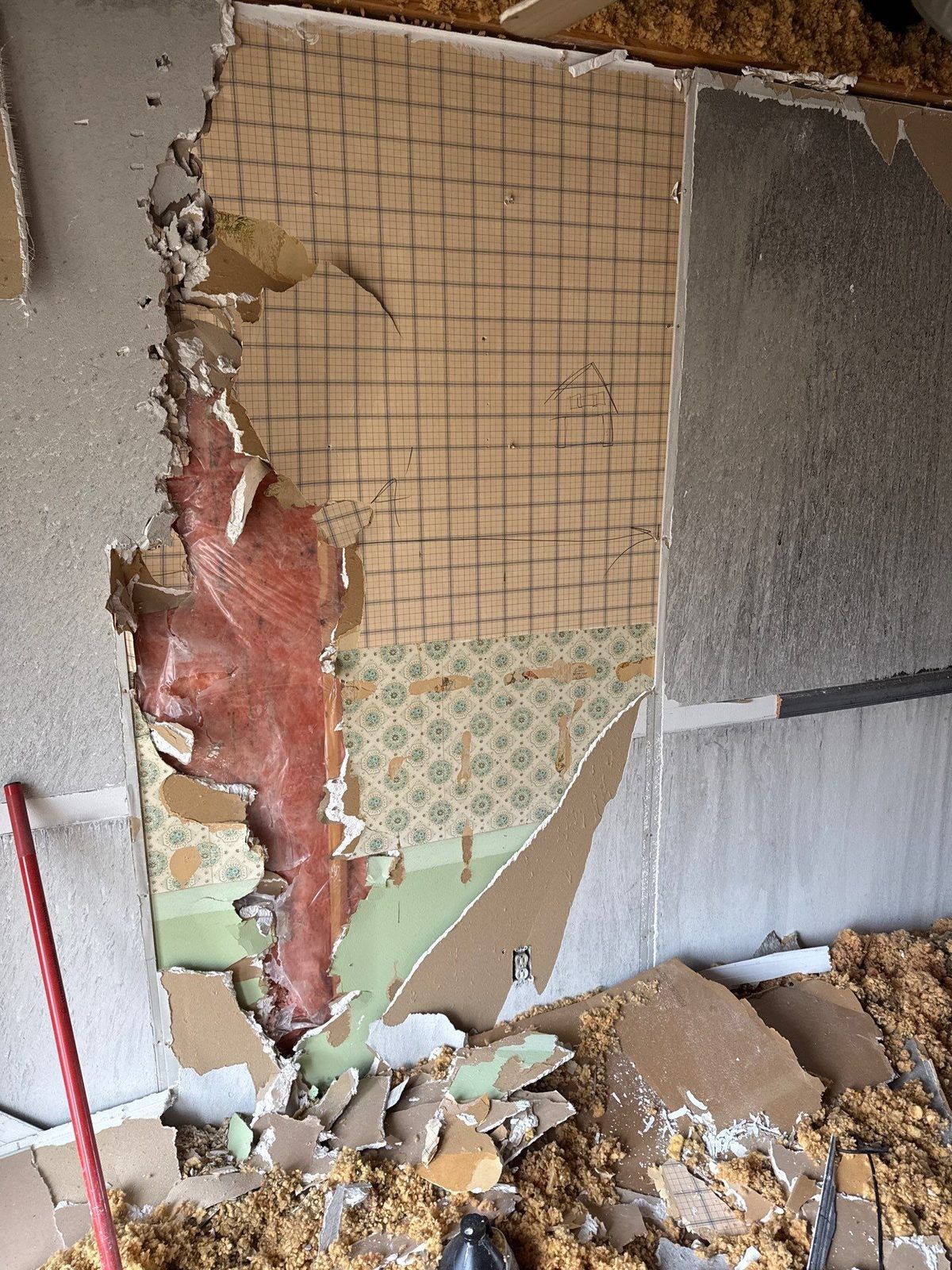 A smoke-damaged wall during demolition