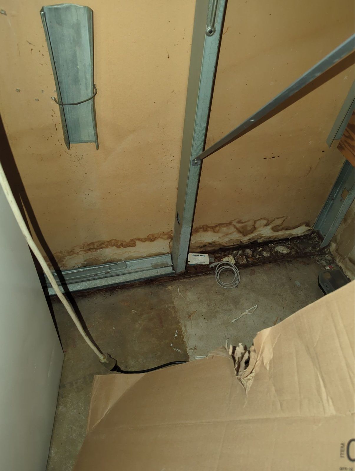 A wall cavity opened up to expose water damage