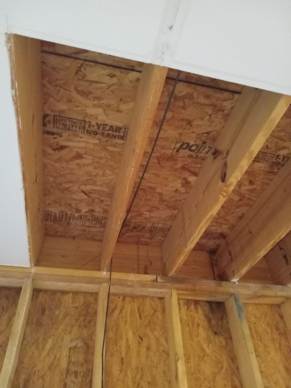 Water-damaged ceiling and wall materials removed down to the framing