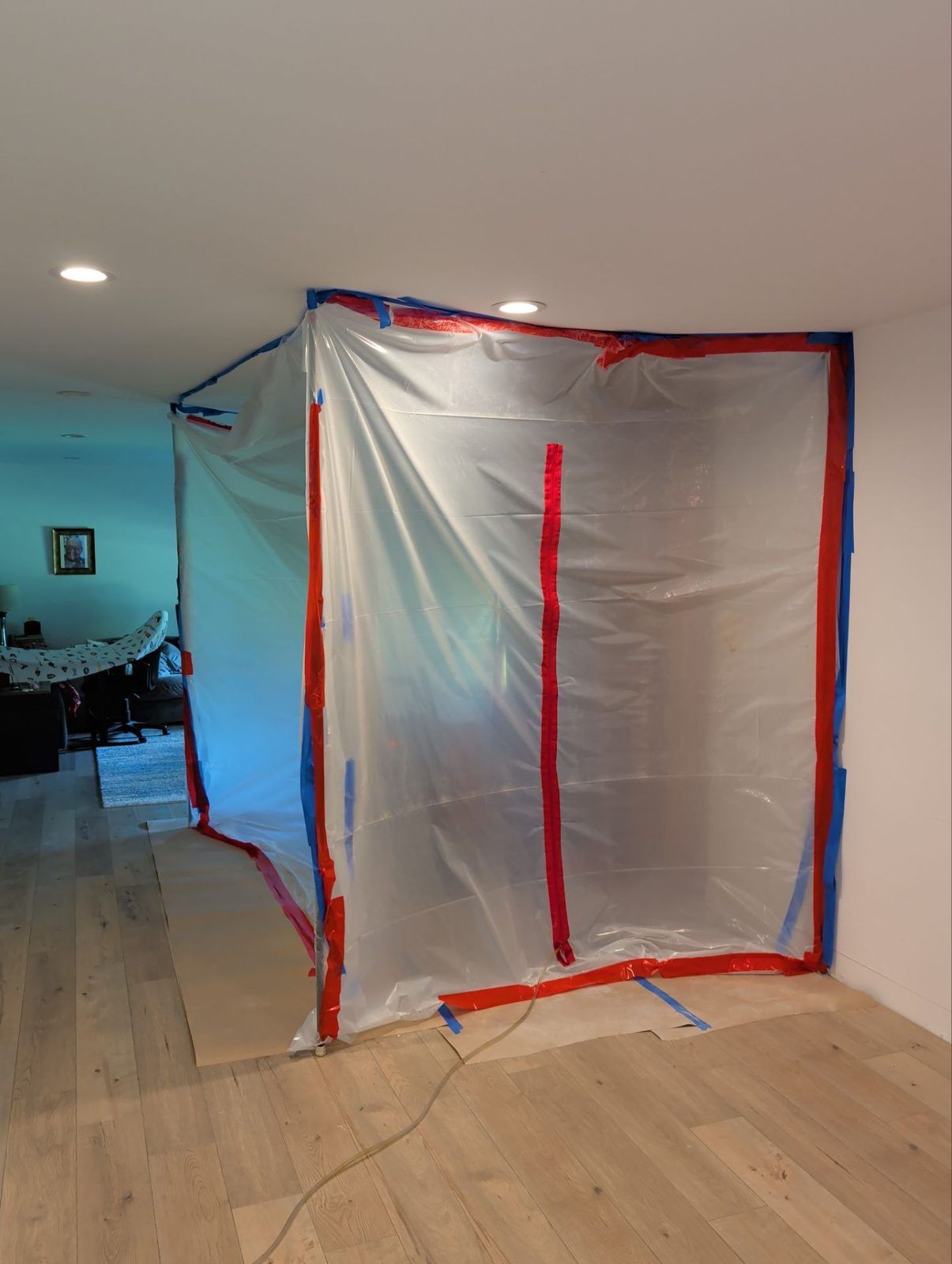 Plastic containment with a zipper door sealing off a work area